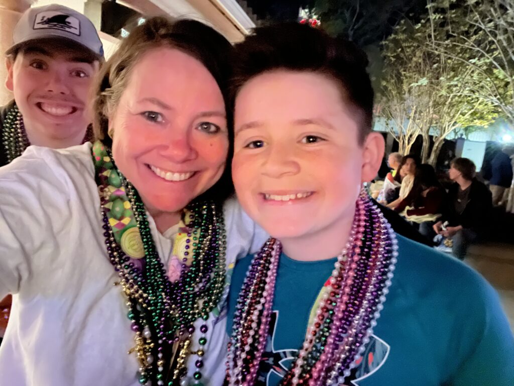 Family photo at Mardi Gras Parade with beads