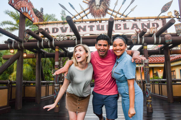 Magic Kingdom Adults without Kids in front of Adventureland Sign