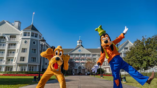Disney Resort Benefits with pluto and goofy in front of Disney's Yacht Club resort